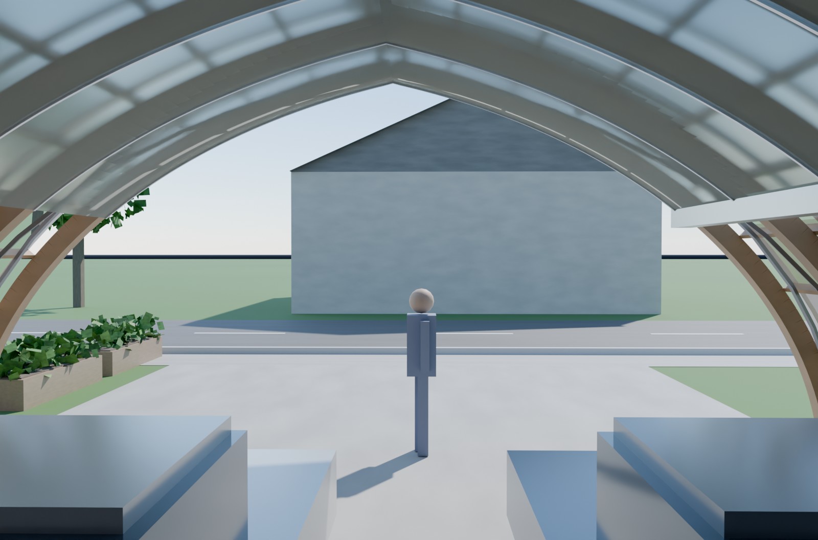 Standing inside a DrivePhab looking out through the open end: timber ribs overhead, cars either side, daylight through the shell