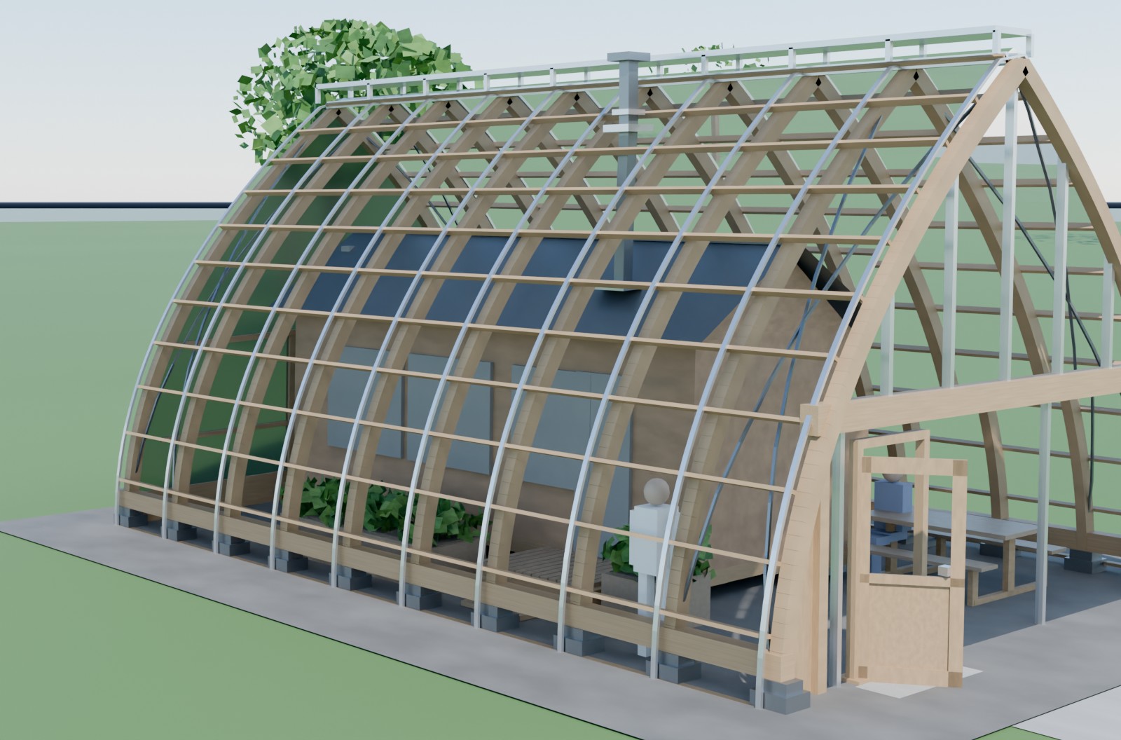 A small Solarship on a gravel pad with a gabled tiny home standing inside it, timber ribs and polycarbonate glazing arching over the unit, its wood-stove flue rising out through the shell